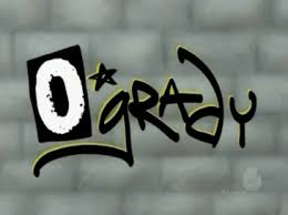 Graffiti-style tag on a brick wall with bold black lettering and a small star.