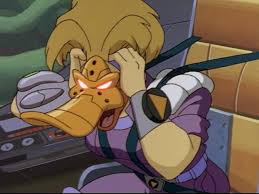 Cartoon duck in a purple outfit holds its head in distress in a control room environment.