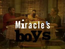 TV talk show scene with three guests seated around a table on a brown-toned set, the title 'Miracles Boys' overlaid on the image.