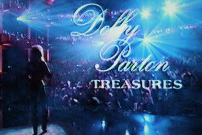 Promotional stage backdrop reading 'Dolly Parton Treasures' with a silhouette on a blue-lit concert stage.